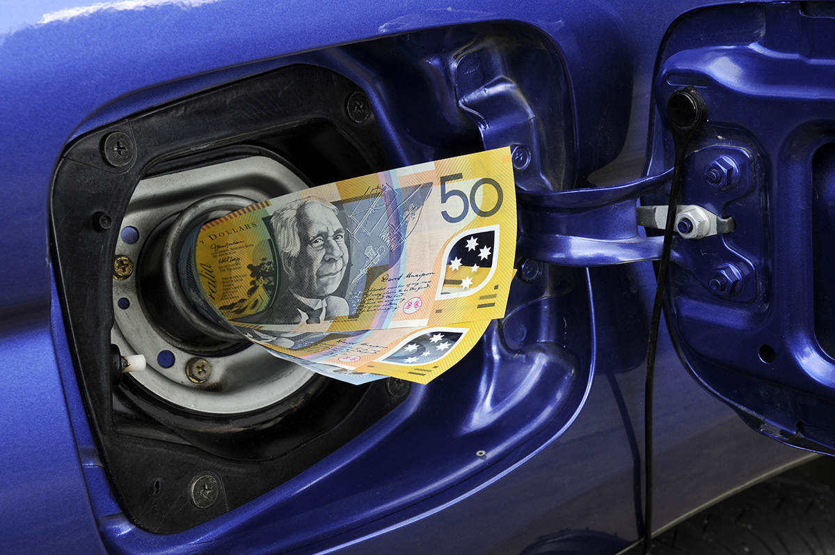 Australian cash going into the petrol tank of a car